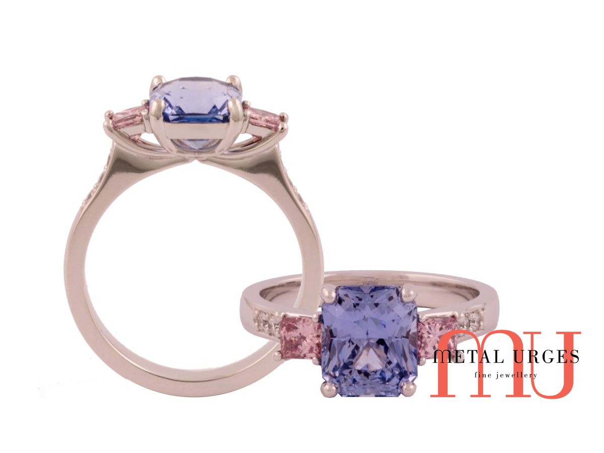 Three stone pink argyle diamond and cushion cut blue sapphire ring.