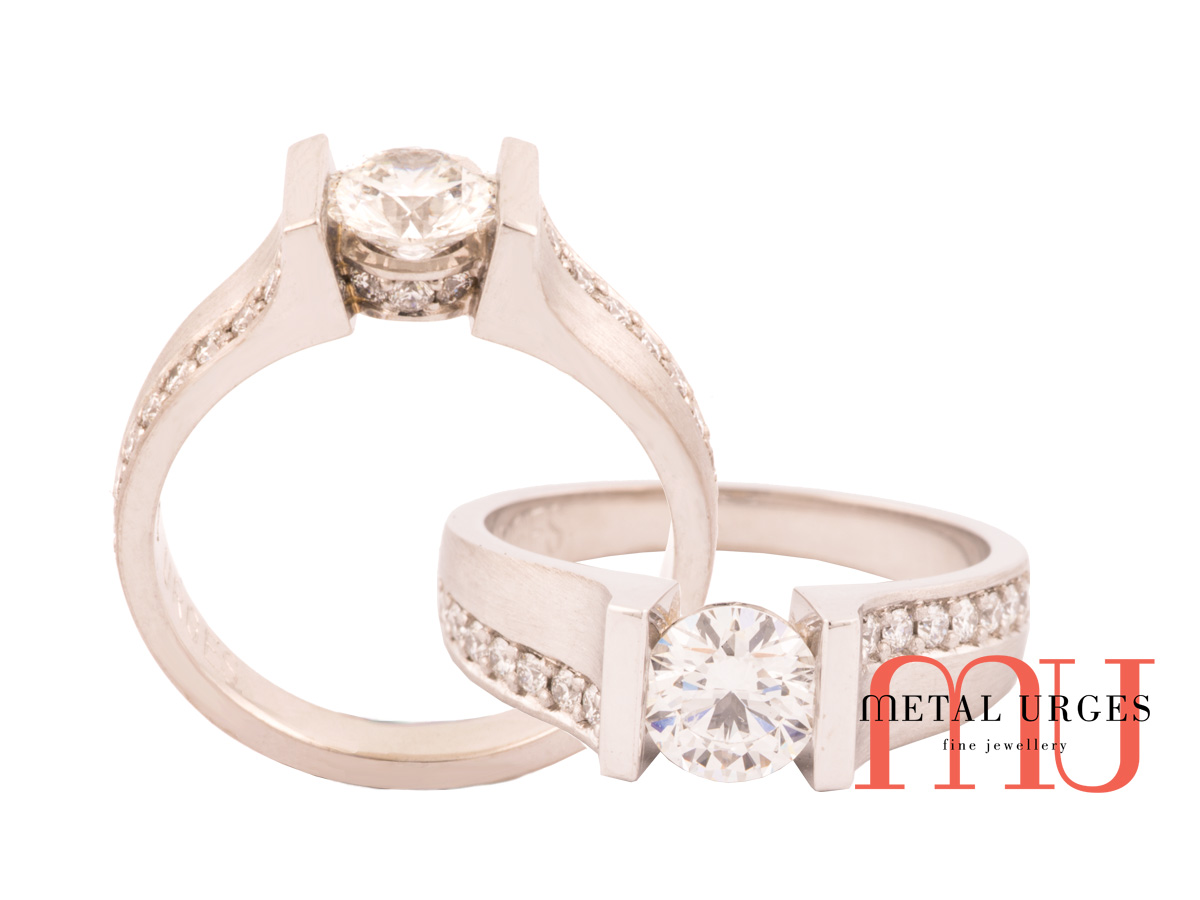 Bar set white GIA certified diamond with bead set highlights.