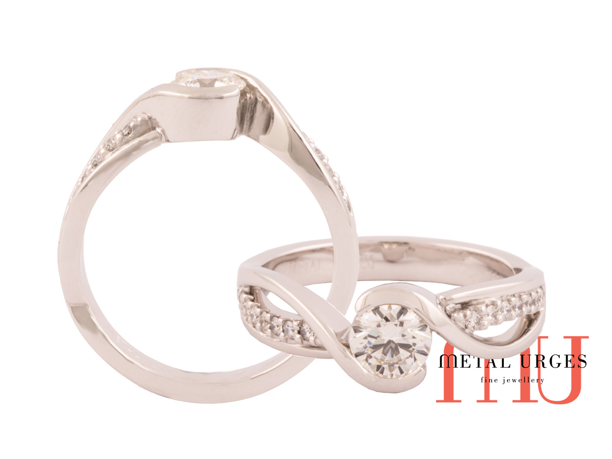 Semi bezel set white diamond bypass style engagement ring in 18ct white gold