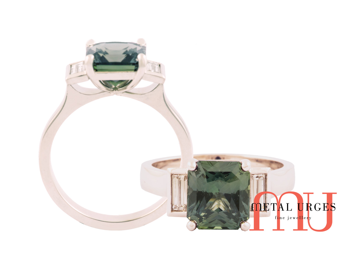 Radiant cut green sapphire ring with side baguette diamonds in platinum