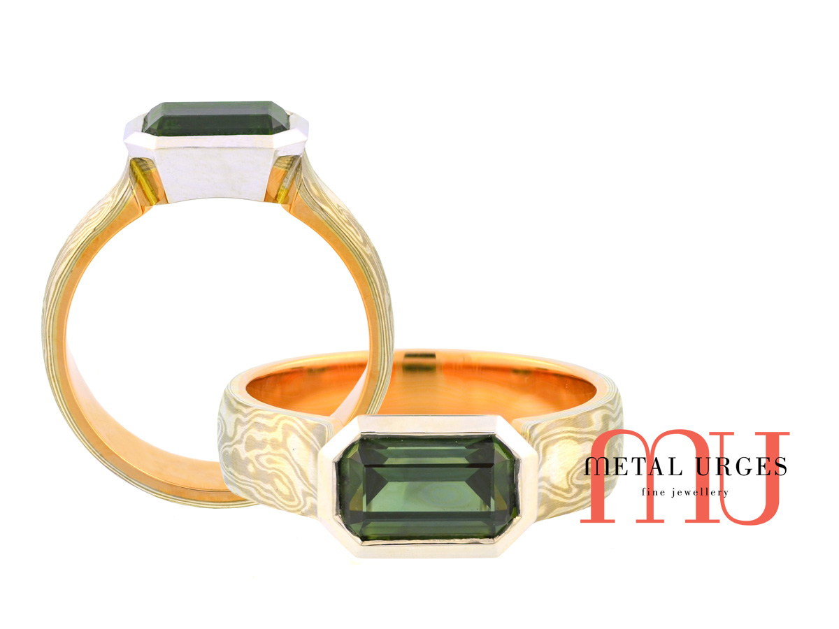 Emerald cut Australian green sapphire and mokume gane engagement ring. Custom made in Australia.