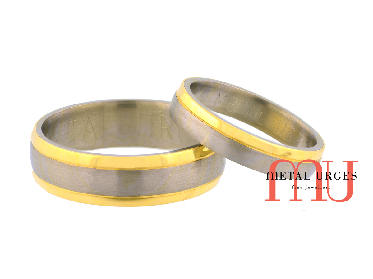 Brushed titanium with polished 18ct yellow gold edge rails matching wedding rings. Custom made in Australia.