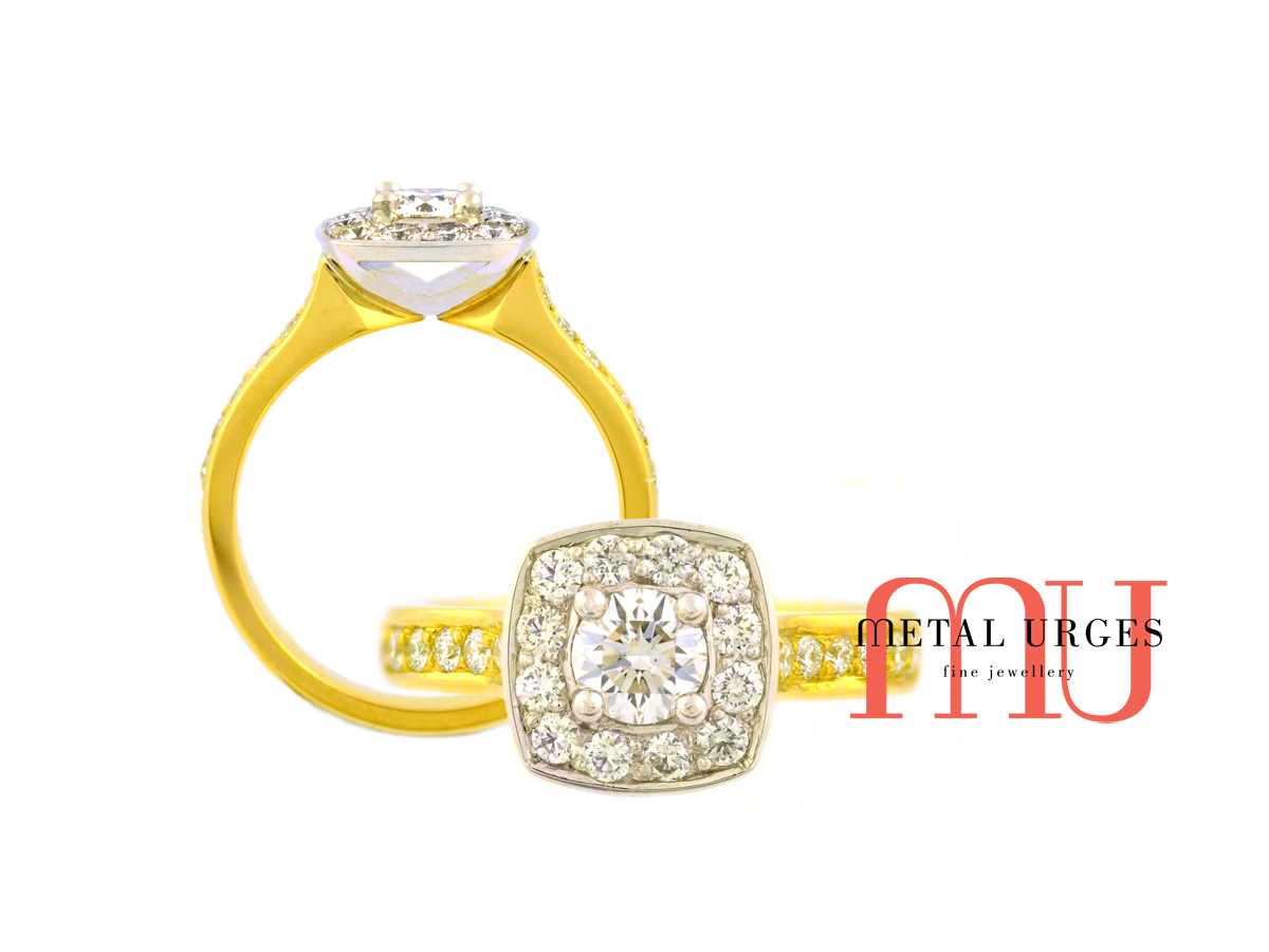 GIA certified round brilliant cut white diamond set in a modern halo cluster. Grain set white diamond shoulders set in an 18ct yellow gold band. Custom made in Australia.