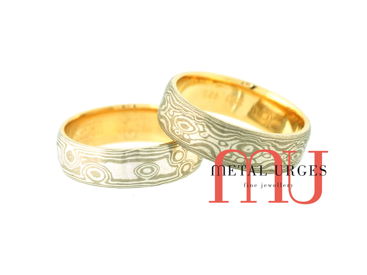 Silver and 18ct white gold and silver Mokume Gane wedding rings with 18ct yellow gold linings. Custom made in Australia.