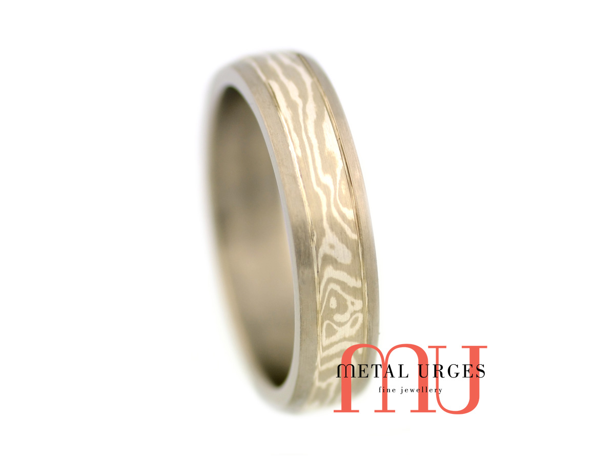 Titanium wedding ring with a central 18ct white gold and silver Mokume Gane feature. Custom made in Australia.
