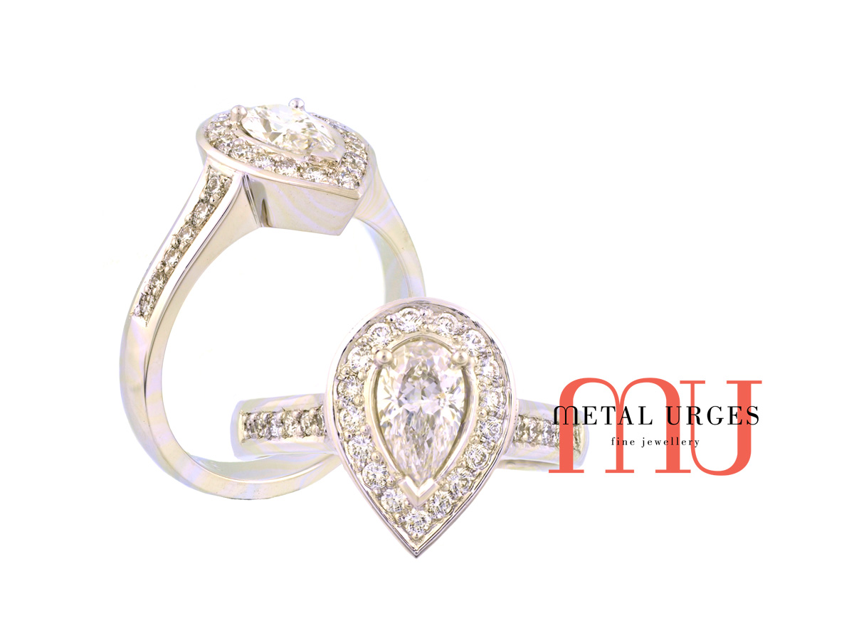 Pear shaped diamond and platinum engagement ring in the modern halo cluster style. Custom made in Australia.