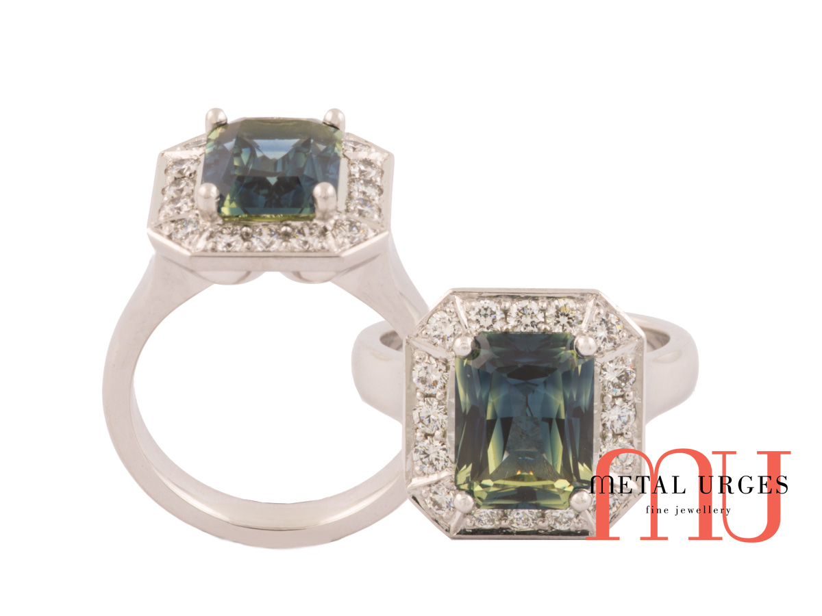 Radiant cut green sapphire with modern cluster set diamonds in 18ct white gold