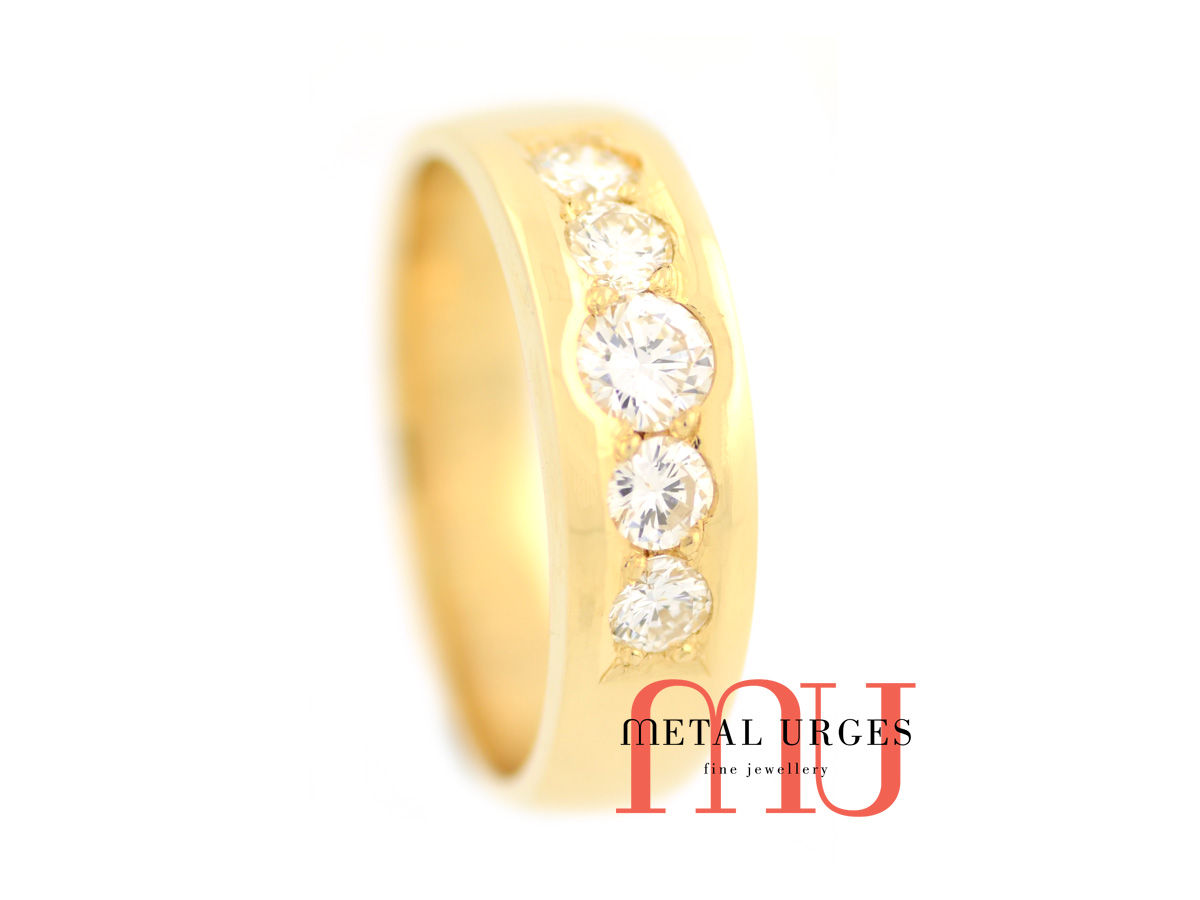 Five grain set round white brilliant cut diamonds set in an 18ct yellow gold band.  Custom made in Hobart.