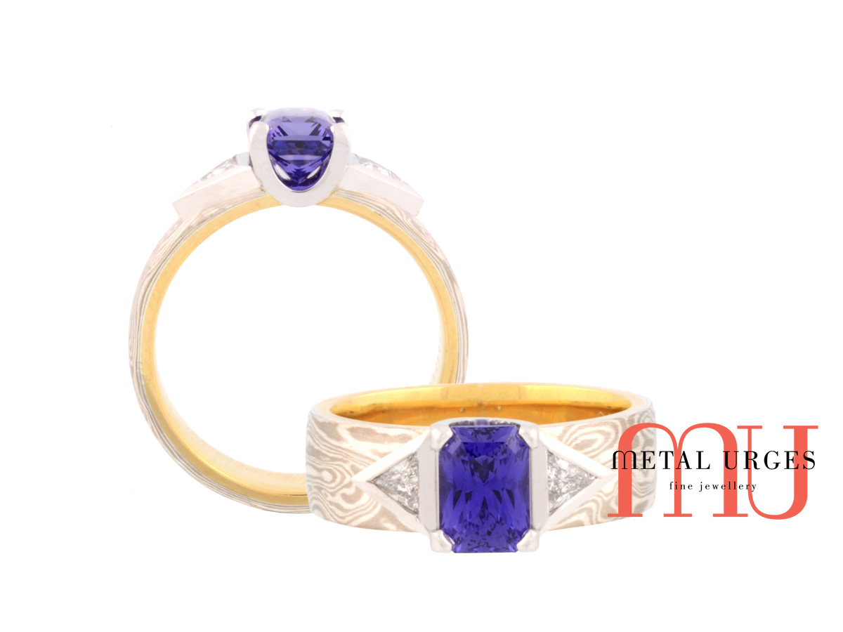 Vibrant blue sapphire and diamond engagement ring in 18ct yellow gold, white gold and silver mokume gane. Custom made in Australia.