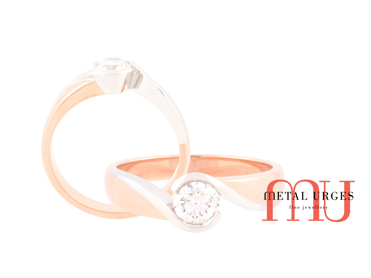 Solitaire 18ct rose gold and white gold GIA certified round white diamond engagement ring with curved and sweeping features.