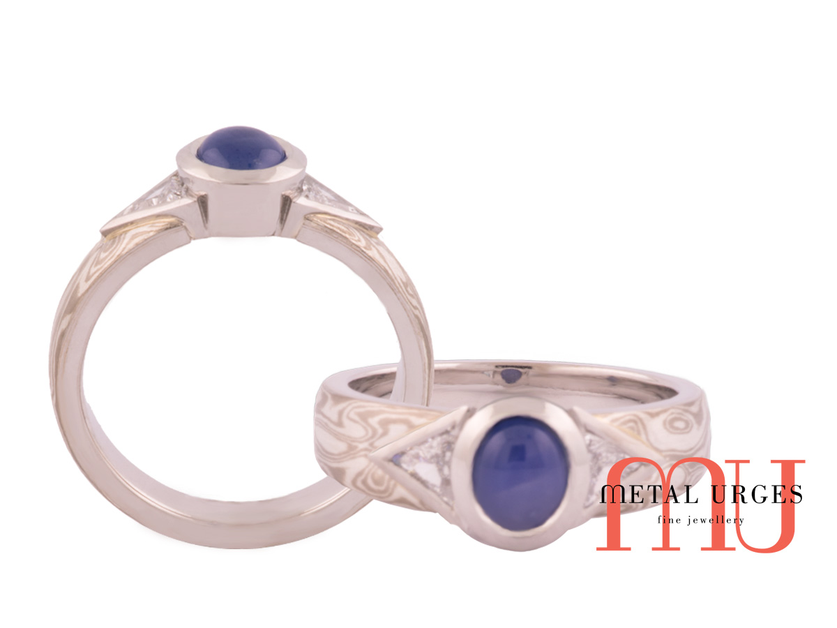 Cabochon natural sapphire with triangular diamonds and mokume gane inlay.