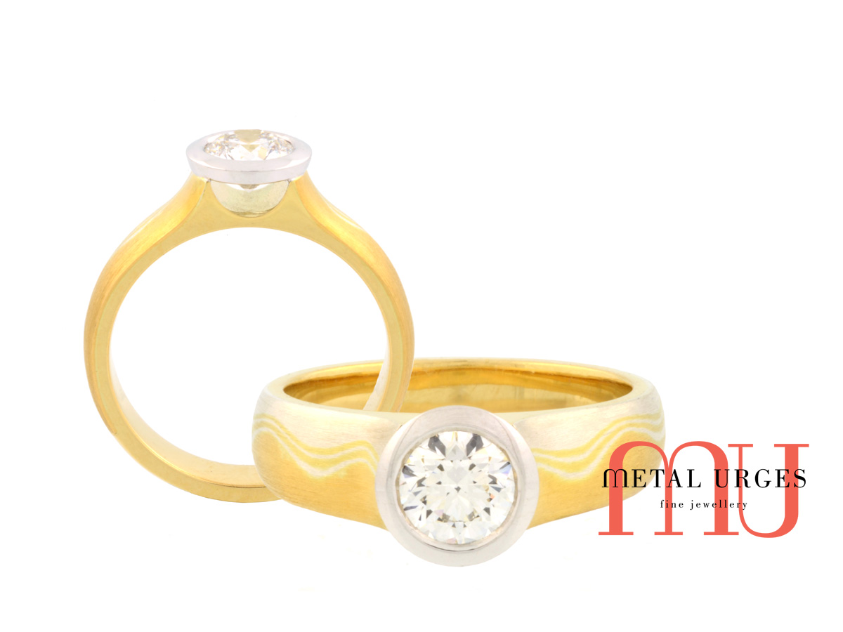 Unique round brilliant cut white diamond and mokume gane engagement ring. Custom made in Australia.