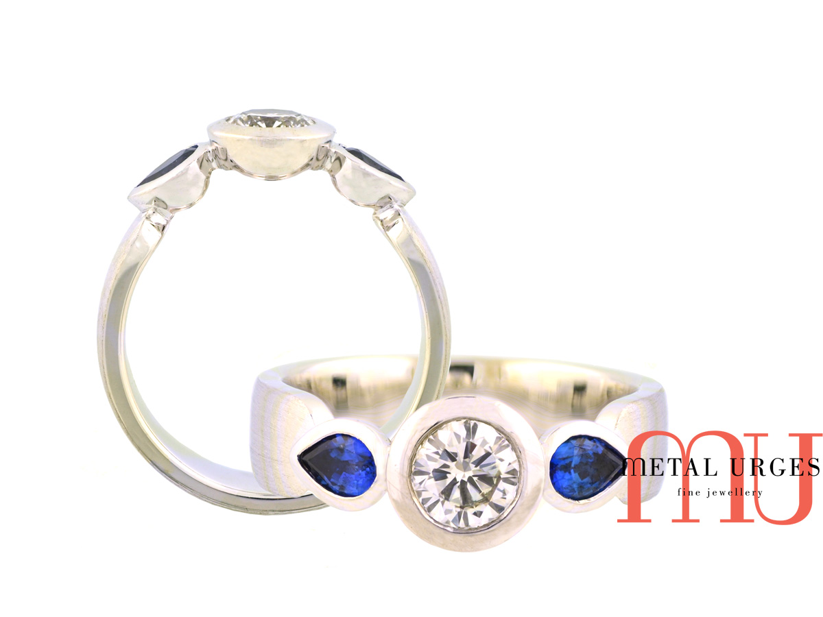 Natural round brilliant cut GIA certified white diamond and Sri Lankan blue pear shaped sapphire engagement ring in 18ct white gold.  Made in Australia.