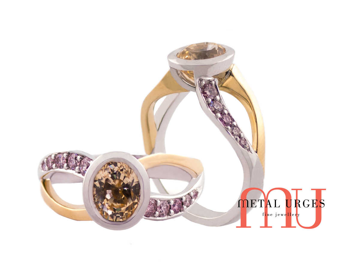 Bezel set yellow sapphire with pink diamonds in yellow gold and white gold band.